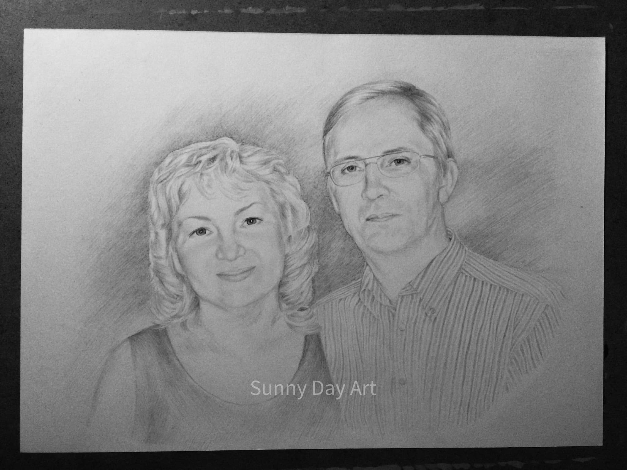 Portrait of a couple, blonde woman smiling, man looking calmly at the camera.