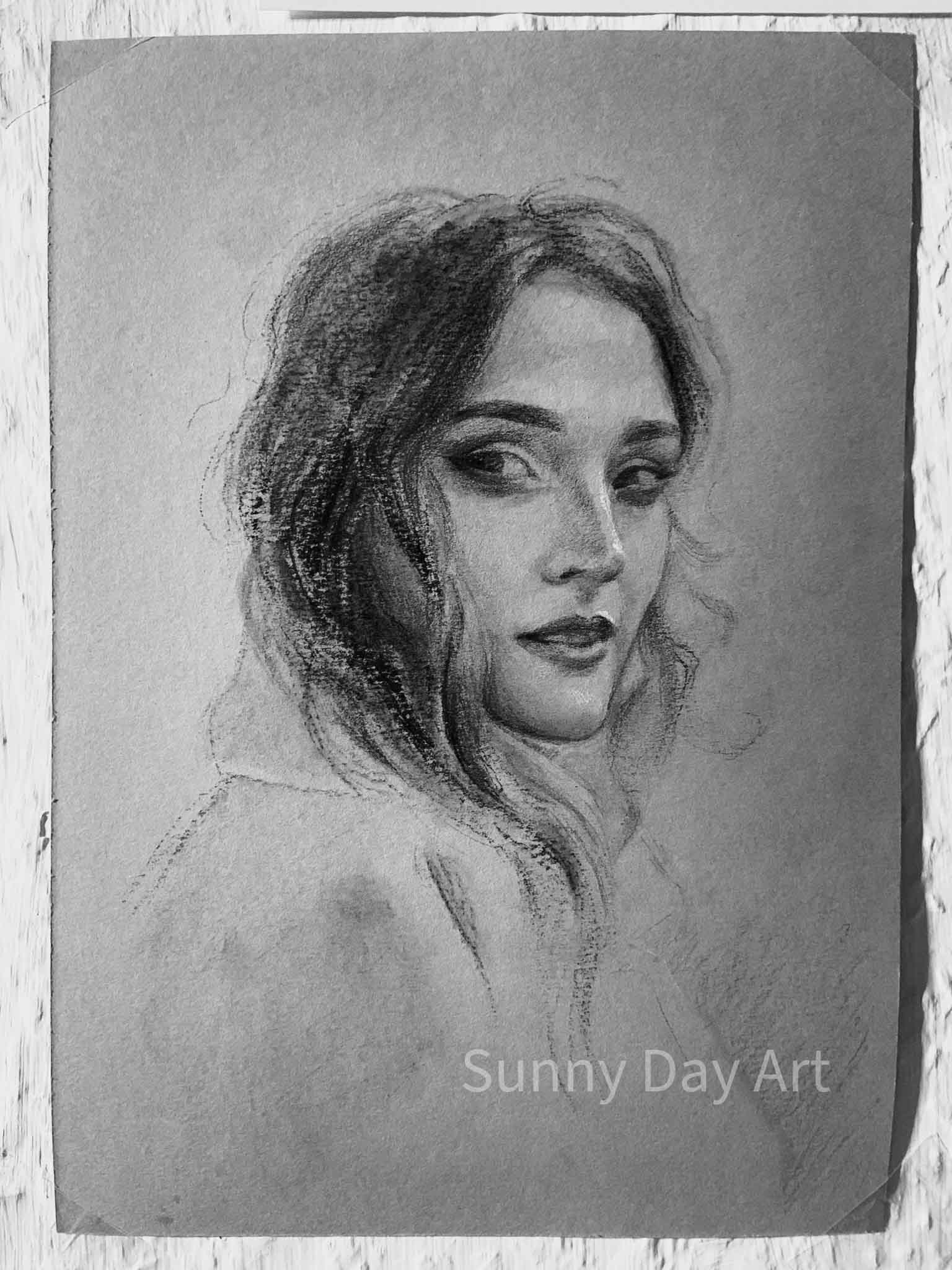 Charcoal-pencil portrait of a girl looking over her shoulder, with a gentle expression.