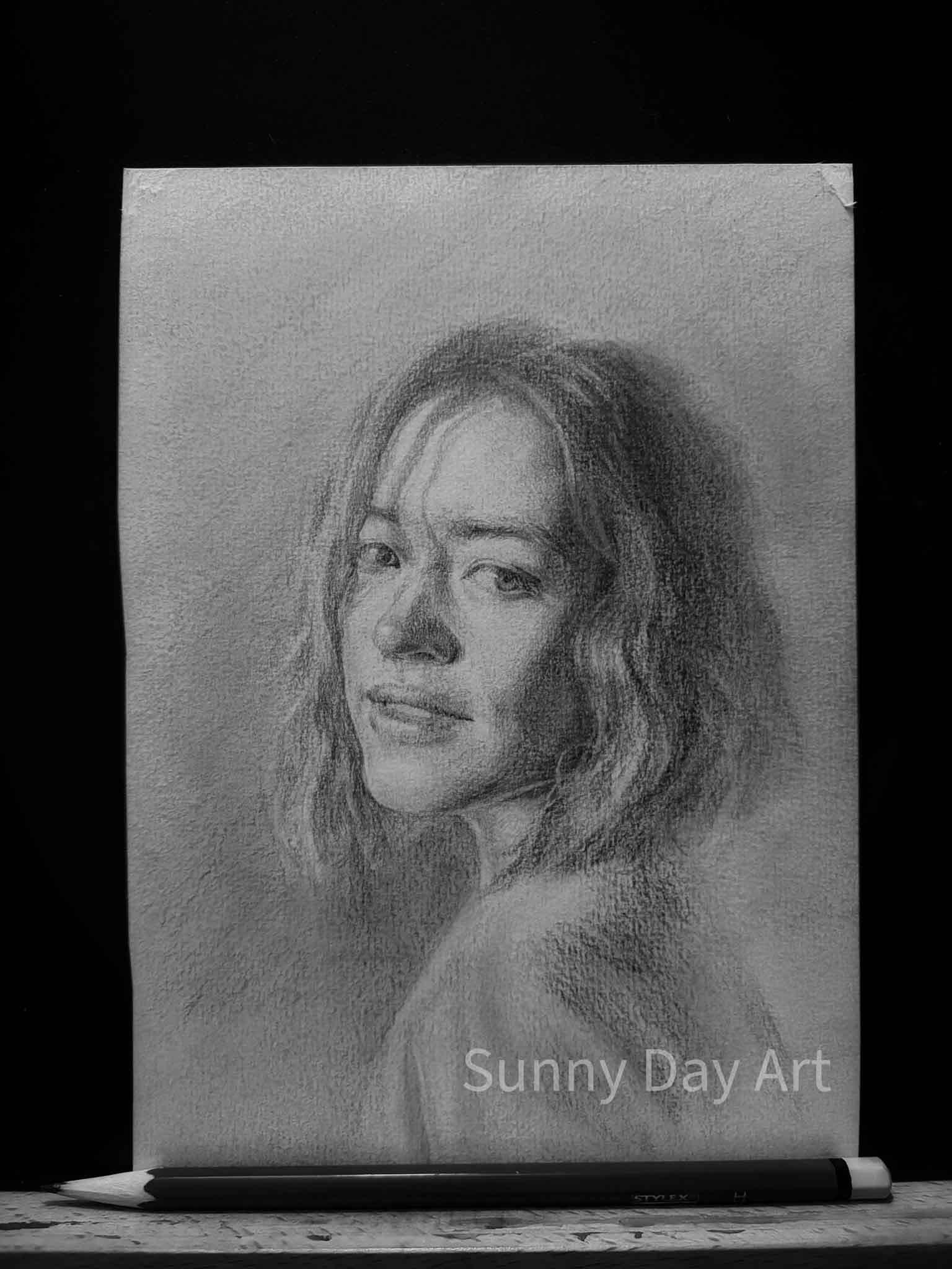 Portrait of a girl with a bob haircut, illuminated by a bright sunbeam, soft light on her face.