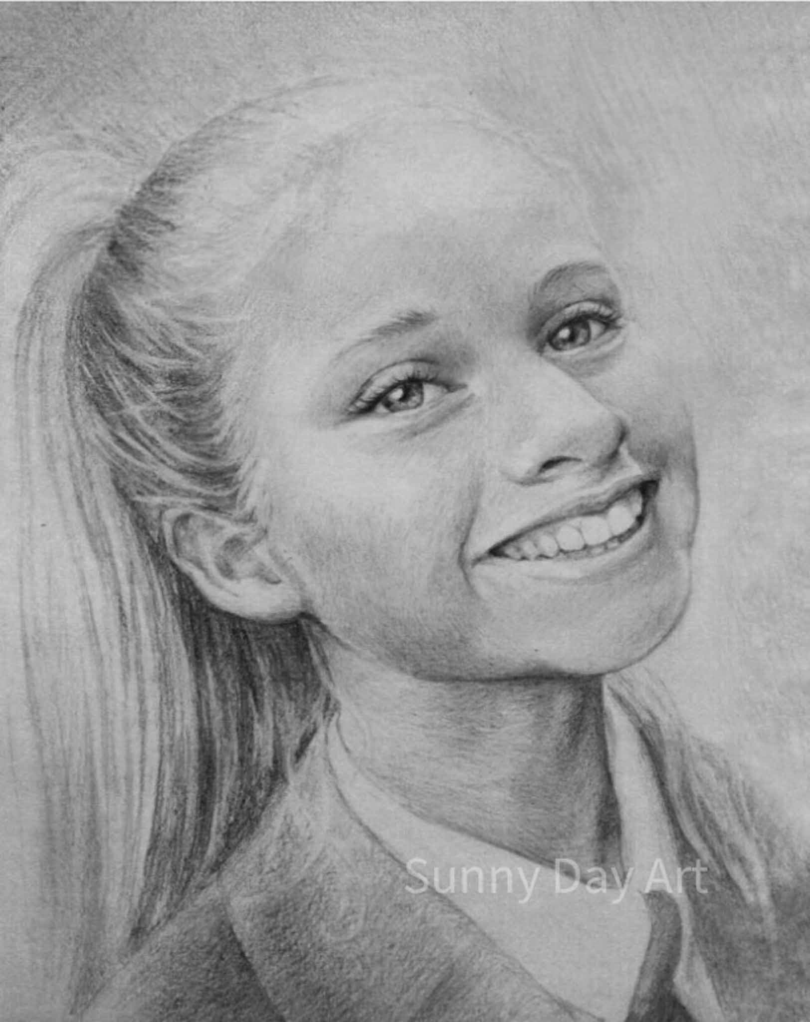 Portrait of a girl with a wide smile, raised eyebrows, blonde hair in a ponytail.